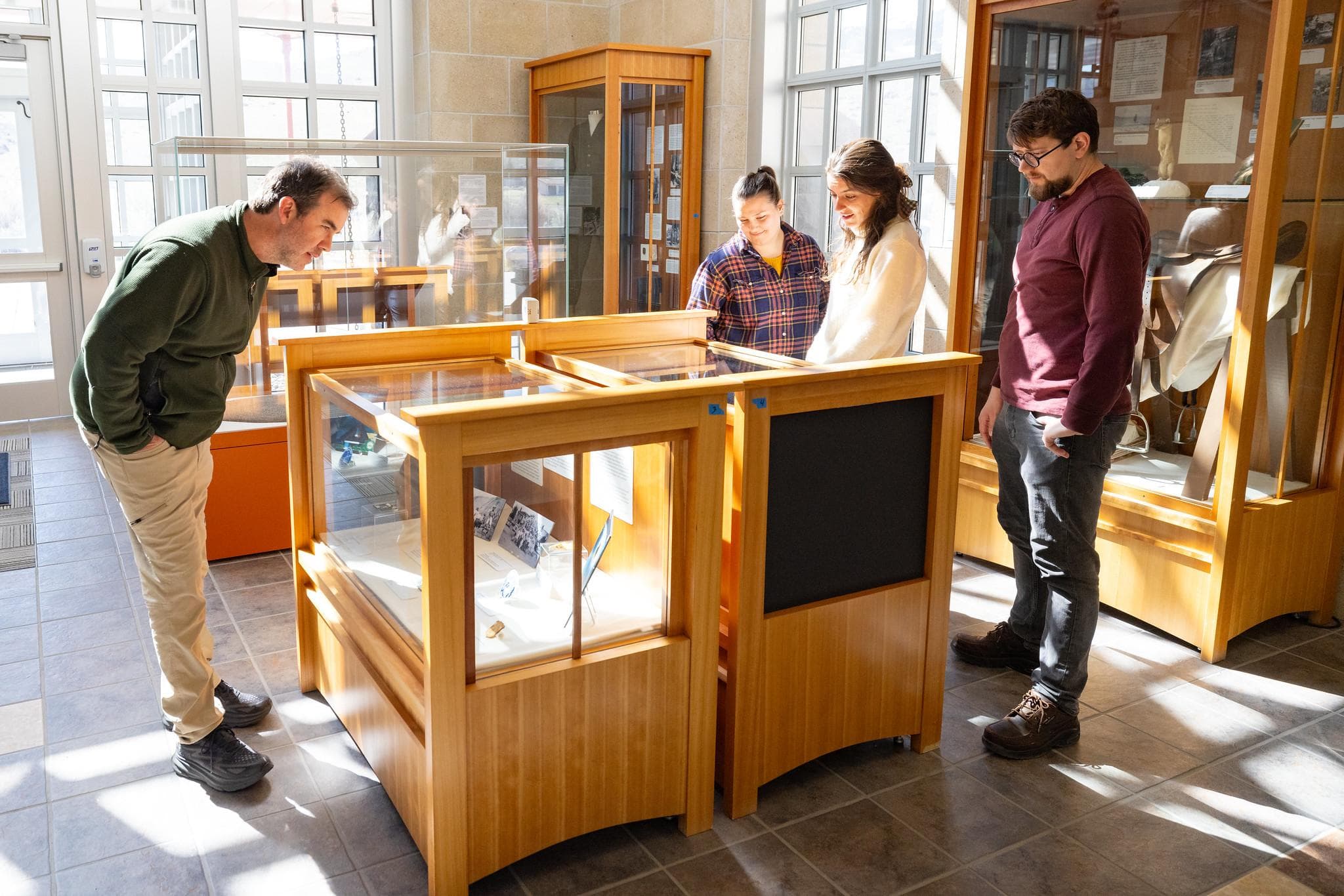 People looking at a variety of exhibits in the lobby of a building