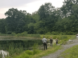 A ranger and Fishing Friday participants on the bank of Hidden Lake.