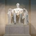 Marble statue of a man sitting on a chair